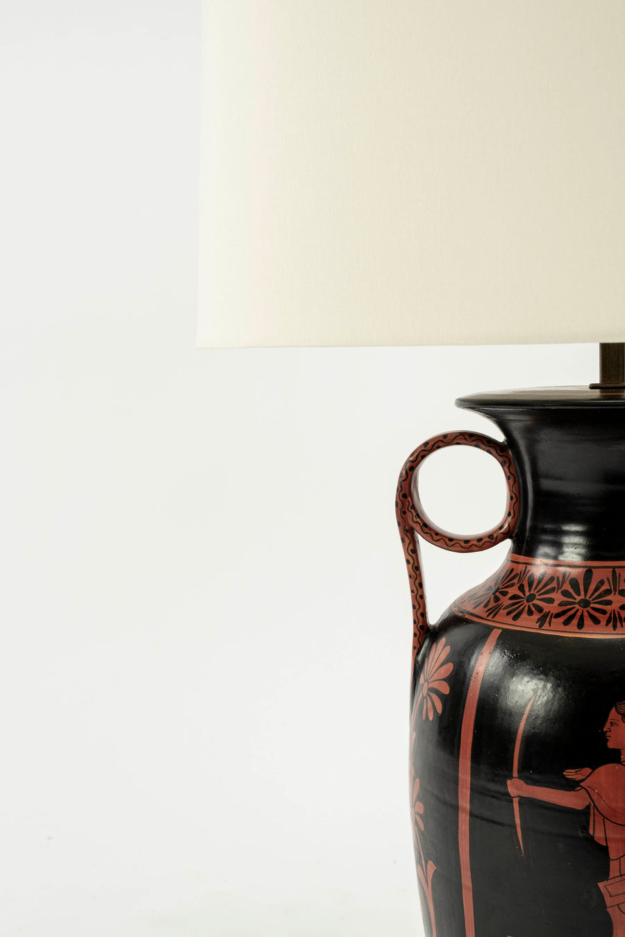 Up-close on one of the two decorative pieces attached to each urn lamp's base.